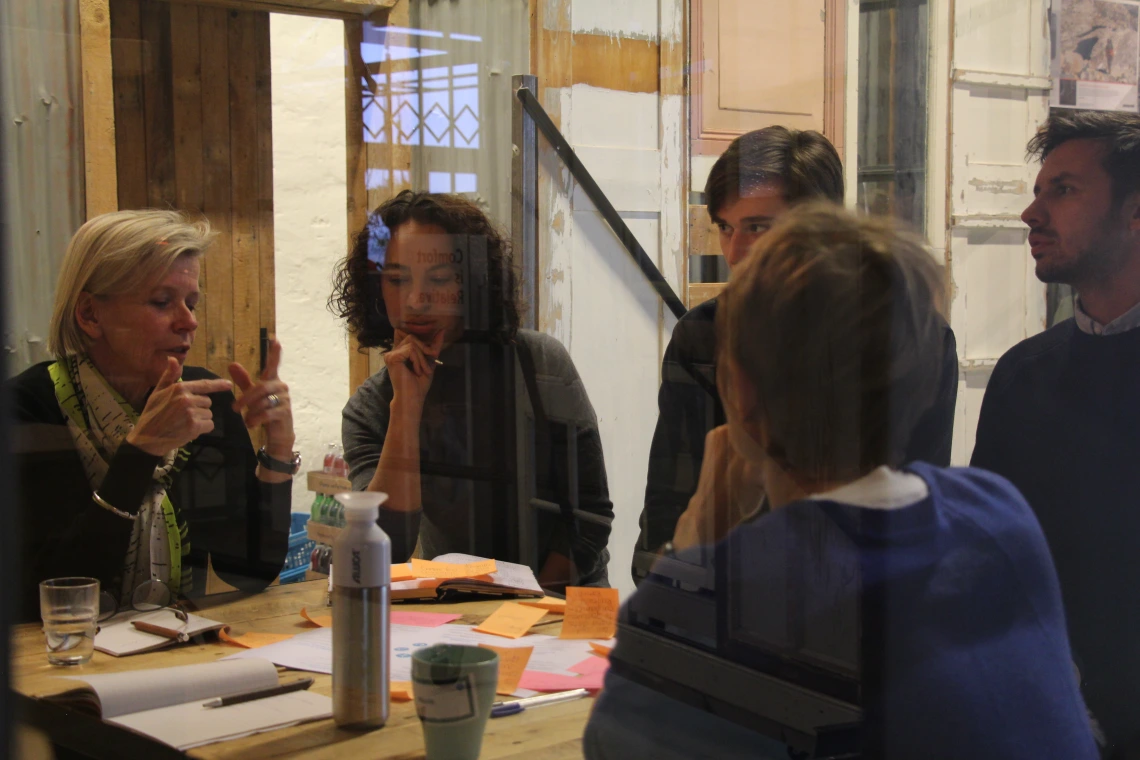 Image of Claire Bates and 4 colleagues at a table Image of Claire Bates and 4 colleagues at a table